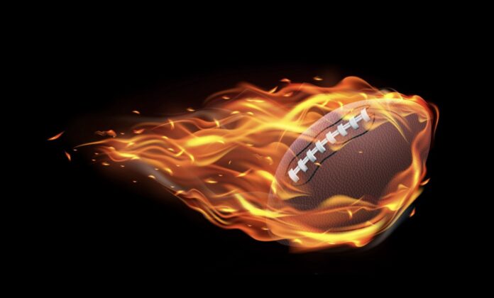 a football in fire with a black background